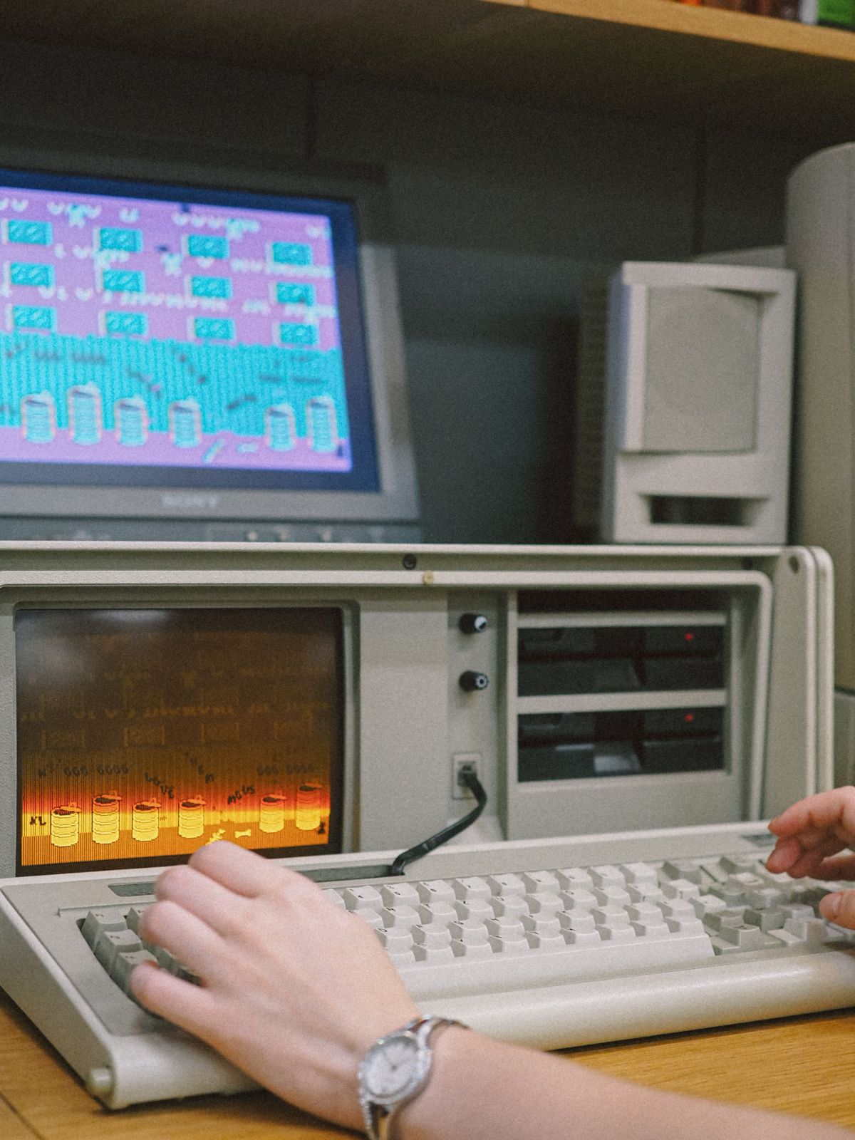 Vintage portable computer with a retro game on screen